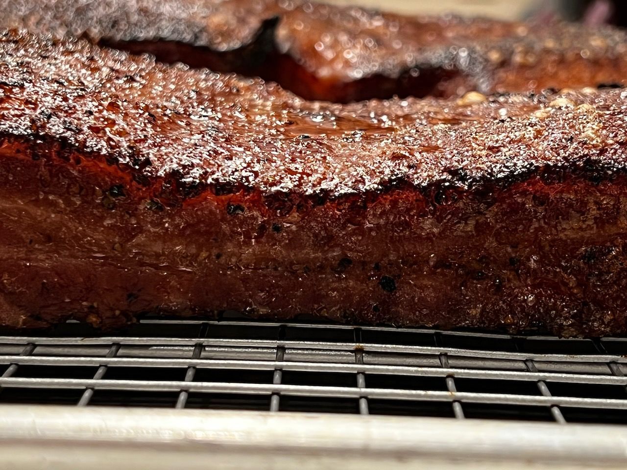 Fully-cooked pork belly resting after smoking.