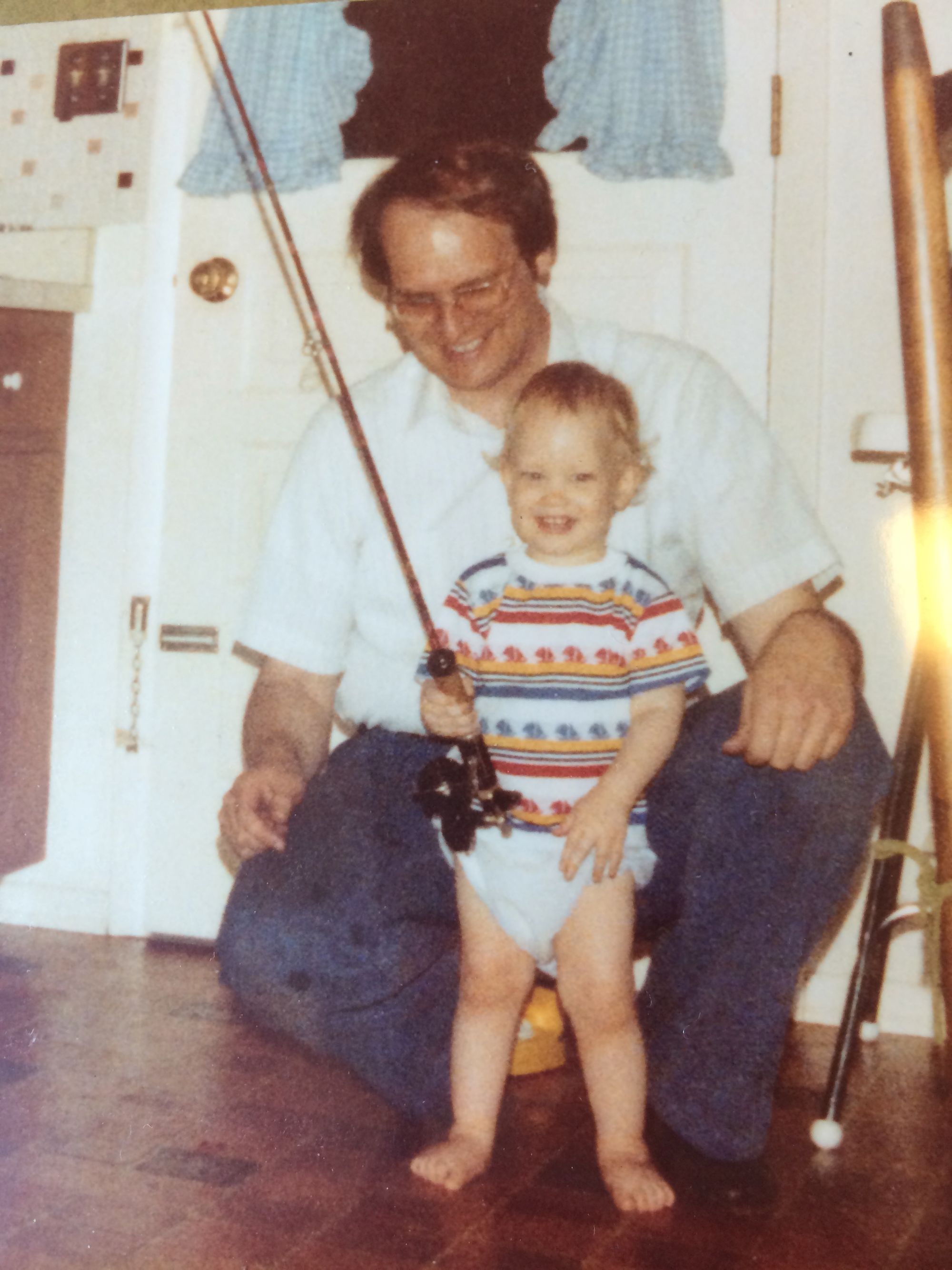 My dad and I in the kitchen, practicing how to hold a fishing rod.